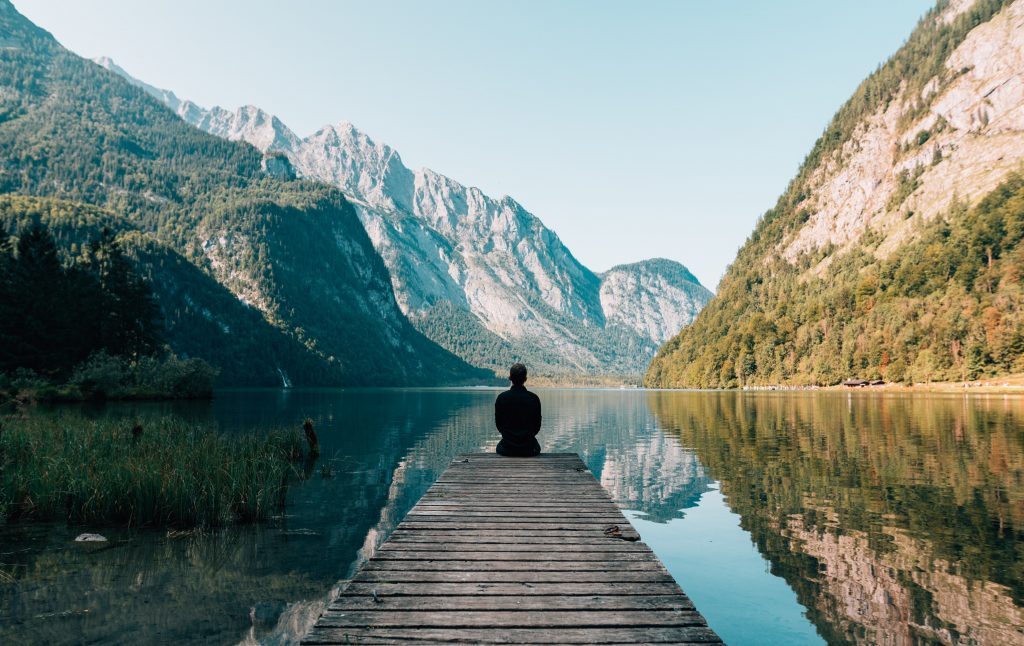 man sitting on wharf aware that God is speaking